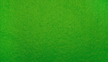 Green felt fabric close-up. Abstract background. The texture of the fibers. Velvet surface.
