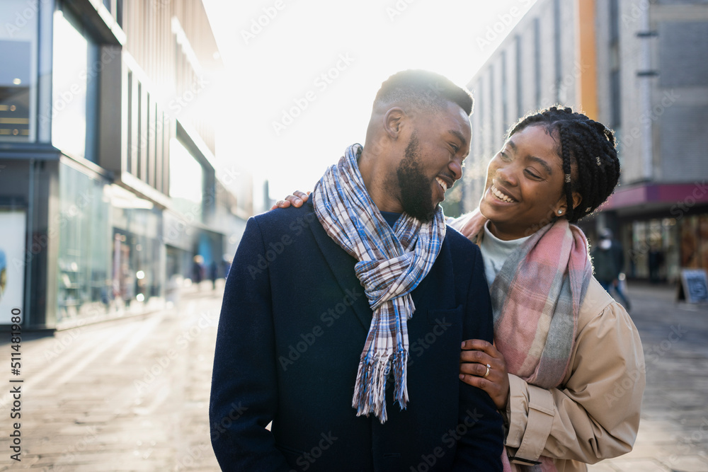 Wall mural portrait of cheerful couple in town smiling