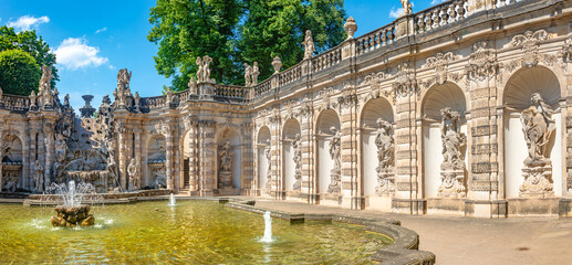 Panoramic view over Zwinger palace, gardens, statues and fountains at historical and museums downtown of Dresden, Germany.