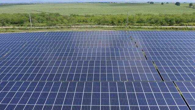 Sideways flyover above El Soco solar photovoltaic panels installed at San Pedro De Macoris in Dominican Republic. Aerial pov