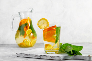 Citrus drink with lemon, orange and mint. Healthy and healthy drink in a transparent glass with copy space