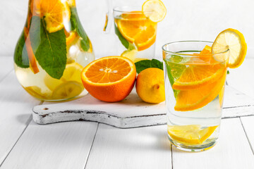 Citrus drink with lemon, orange and mint. Healthy and healthy drink in a transparent glass with copy space