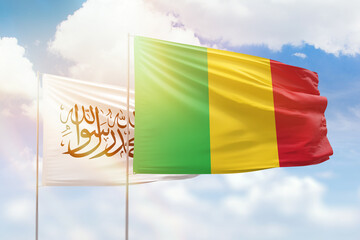 Sunny blue sky and flags of mali and afghanistan