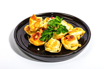 Fried dumplings with parsley and pepper isolated on white background. Trendy vegan food