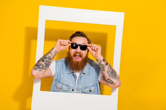 Portrait of masculine brutal positive man hands touch glasses isolated on yellow color background