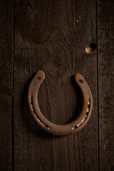 old horseshoe on wooden background