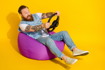 Photo of cool funky man wear jeans waistcoat sitting beanbag playing video game empty space...