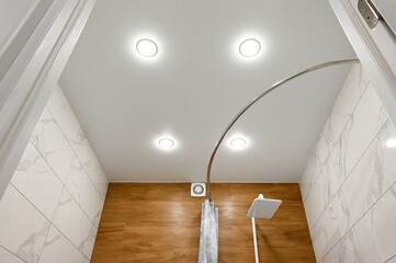Stretch ceiling in the bathroom with built-in lighting.