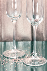 Festive background with glassware. Two empty shiny glasses for wine and champagne on the table