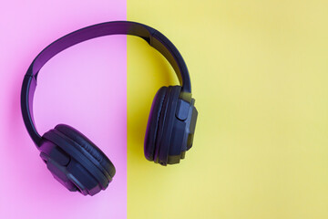 Black Headphone on pink and yellow background