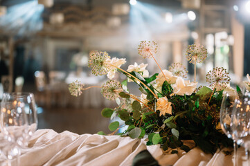 Table setting. On the banquet table there are plates with napkins and name cards, glasses and cutlery