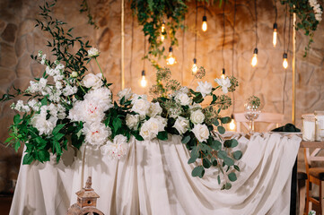 Beautiful groom and bride table decorated with natural materials and a lot of flowers