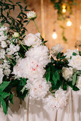 Beautiful groom and bride table decorated with natural materials and a lot of flowers