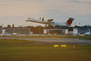 Fototapeta na wymiar The big passenger plane takes off at the city airport.