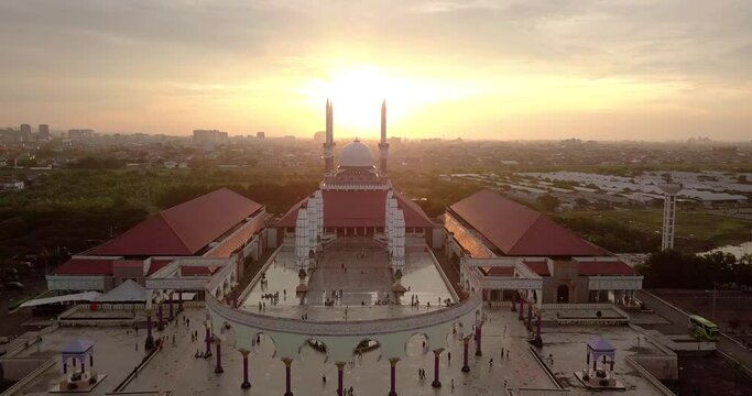 Aerial view of the great Mosque of Central Java (MAJT) in suset time. Th sun is orange and the weather is cloudy.