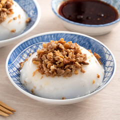 Taiwanese savory rice pudding Wa gui with chopped dried radish and soy sauce