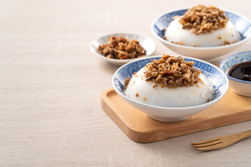 Taiwanese savory rice pudding Wa gui with chopped dried radish and soy sauce