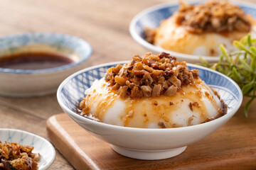 Taiwanese savory rice pudding Wa gui with chopped dried radish and soy sauce - obrazy, fototapety, plakaty