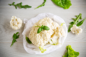 inflorescences of small cauliflower on a light wooden table