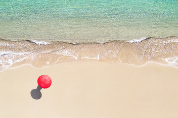 Top view of woman with red summer umbrella walking tropical Seychelles sand beach. Blue, turquoise transparent water surface of ocean, sea, lagoon. Aerial, drone view
