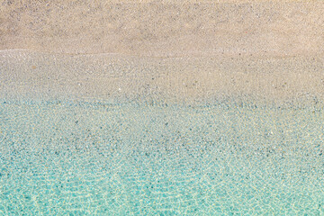 Top view of tropical Seychelles sand beach. Blue, turquoise transparent water surface of ocean, sea, lagoon. Horizontal background. Aerial, drone view