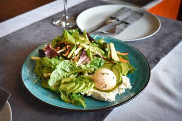 Salad with poached egg and avocado