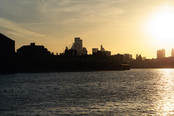 city skyline at sunset in London England near the river 