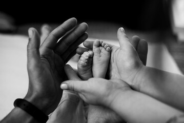 Baby feet before christening in church. Mom and her Child. Beautiful conceptual image of Maternity