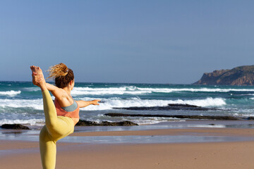 Young blonde woman doing yoga pose in the beach - Praia do Gincho - Sintra - Portugal