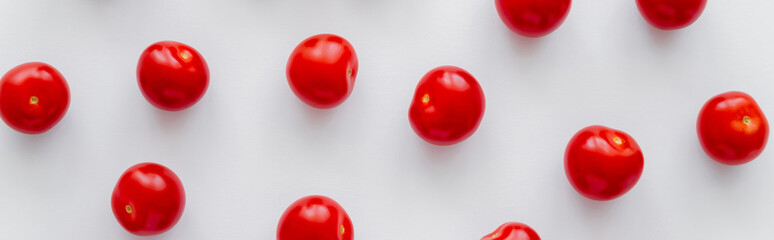 Flat lay of whole cherry tomatoes on white background, banner.