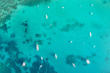 Port, dock with boats, cruise ship, yachts in blue, turquoise sea water. Summer vacations and travel concept. Marina. Aerial, top, drone view