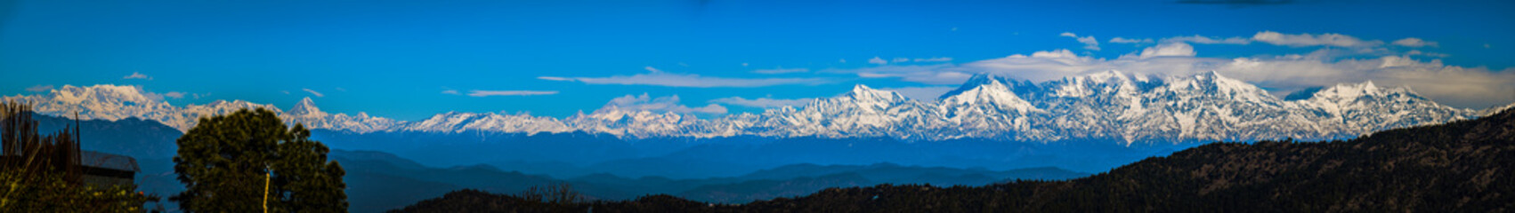 Snowy peak Himalayan mountain range panorama view extreme wide viewing mountains of India