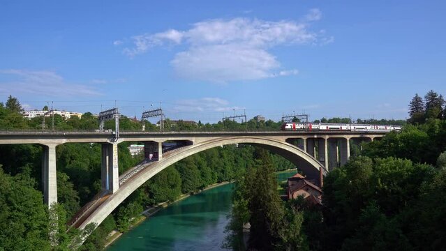 SBB train crossing Lorraine Railway Viaduct over Aare River at City of Bern on a sunny summer day. Movie shot June 16th, 2022, Bern, Switzerland.