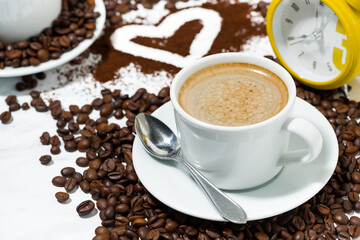 cup of espresso alarm clock and coffee beans conceptual photography