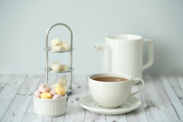 Green tea, Sweets, teapot, milk, on a white background
