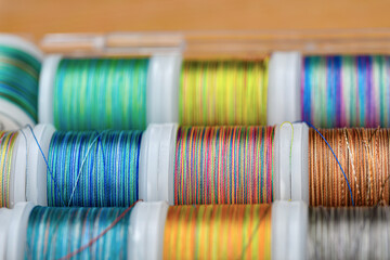 A set of colored rainbow threads for sewing and embroidery.