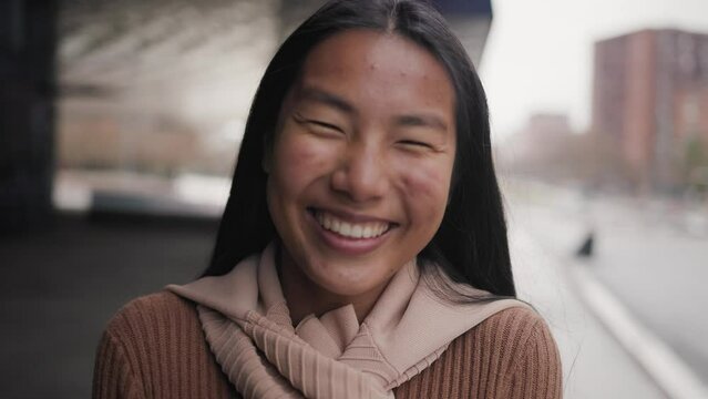 Happy young Asian girl smiling in camera