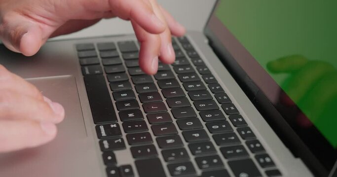 Freelancer types text on laptop preparing new article