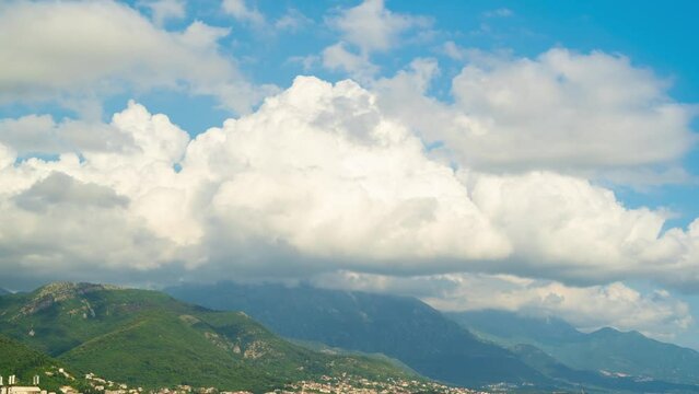 Time lapse of clouds and snow clad mountains while blue sky in the background