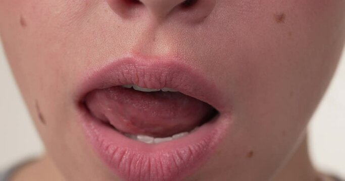 Cropped face of caucasian woman licking her mouth. Close up. Isolated on white background.