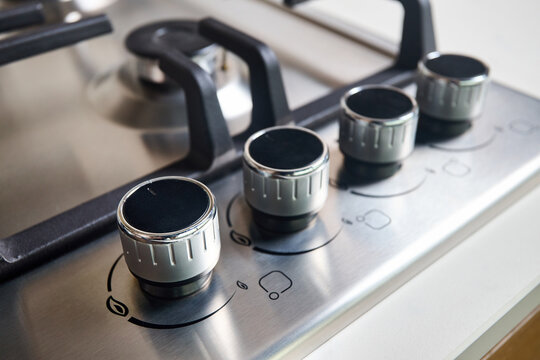 Hob Cooker Oven Grill Stainless Steel Control Knobs Selective Focus Over Out Of Focus Oven With Burner Background.