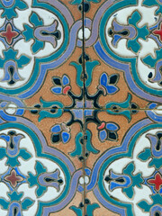 Vintage glazed tiles of vivid colours on the wall in downtown district of Toledo, Spain. Classical spanish decoration