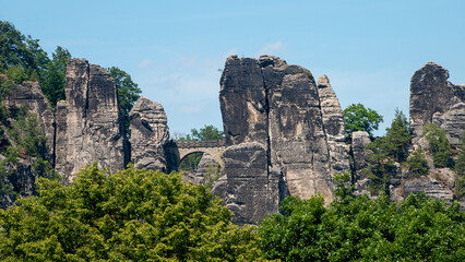 Panoramic view over monumental Bastei sandstone pillars and ancient bridge near Kurort Rathen village in the national park Saxon Switzerland by Dresden and Czechish border, Saxony, Germany.