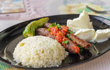 Delicious Turkish Traditional Manisa Kebap, Tire Kofte serving on metal plate