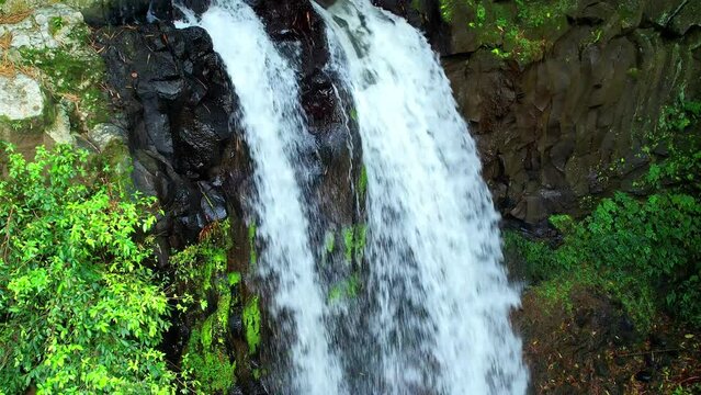 Camera to go down where we can see the water falling at Rio do Ouro waterfall at Roca Agostinho neto in Sao Tome,Africa