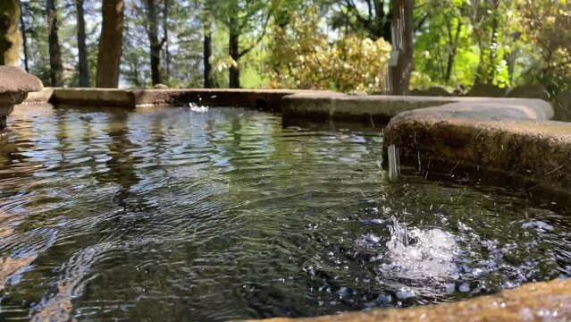 Water dropping on a stone fountain in Parque La Salette, Oliveira de Azem&eacute;ies, Portugal