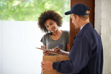 Delivering direct to your door. Shot of a courier making a delivery to a smiling customer.