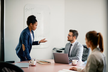Group of entrepreneurs communicating while working on new business project during the meeting.
