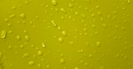 Fototapeta na wymiar Abstract water drops on the yellow green wall. Suitable for promotion and advertising, website, tech industry and company, etc. 