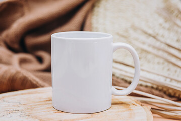 Mock up of white blank coffee mug perfect for your own design or quote on brown cozy background.
